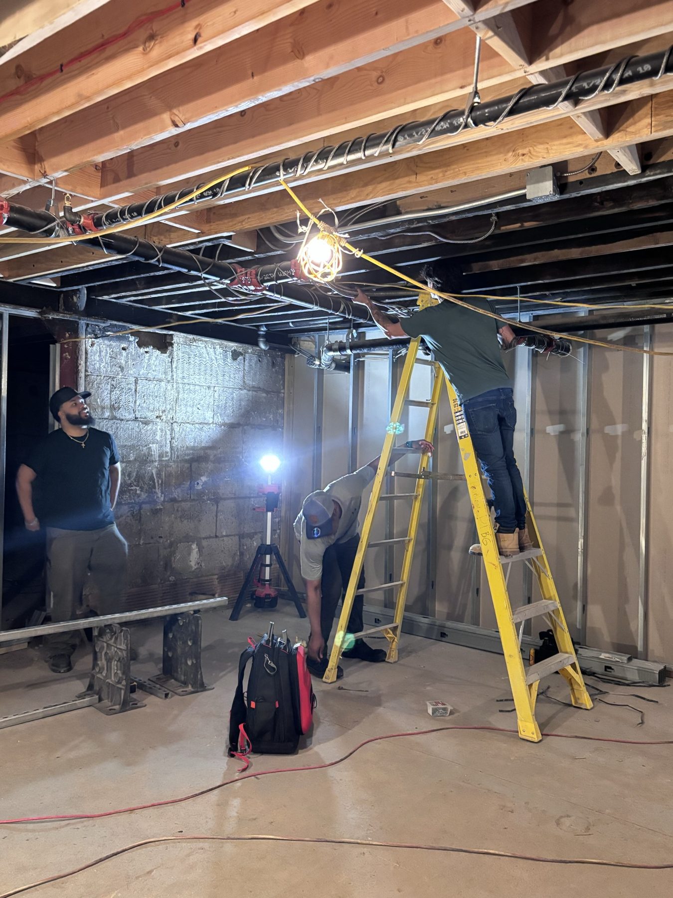 Ladder work at the basement rough-in site